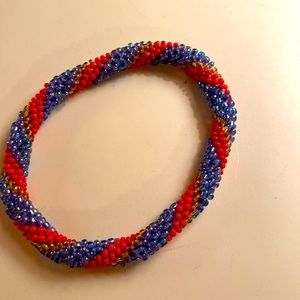 Red, purple, and gold beaded bracelet